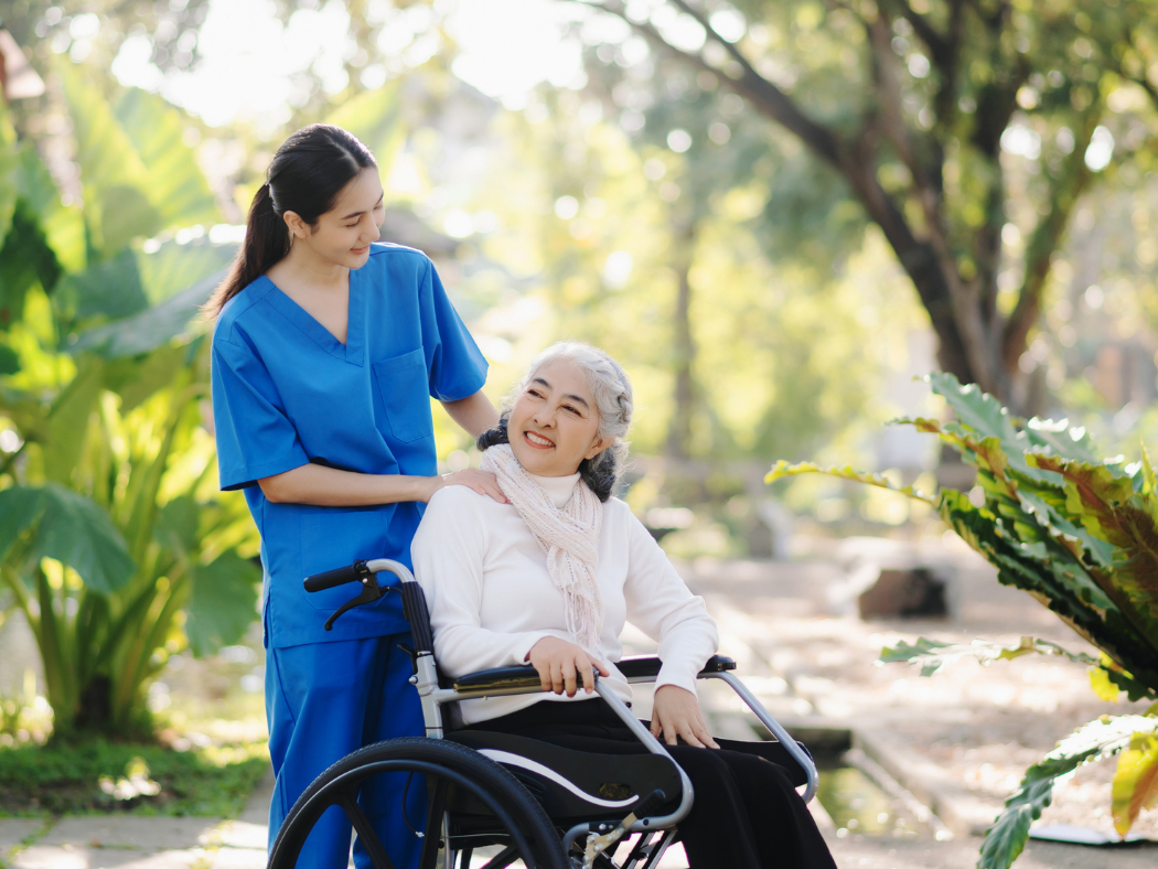 Support worker with participant in an outdoor setting.