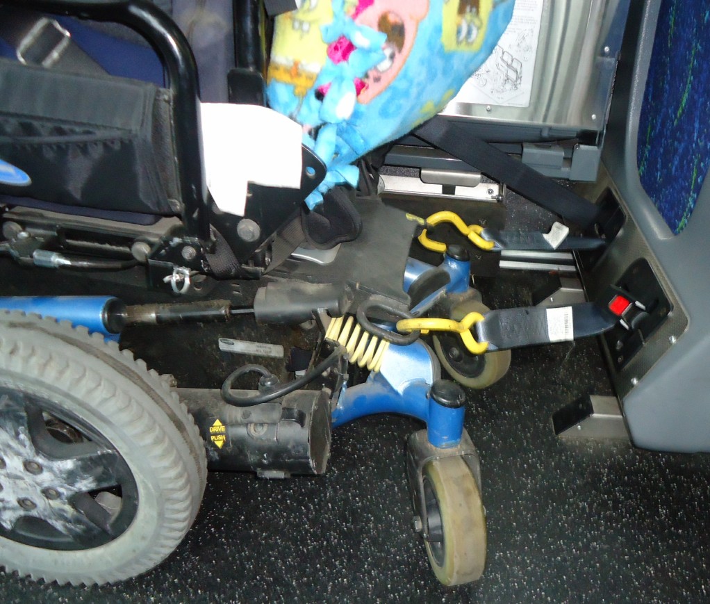 Wheelchair safety securement mechanism inside a bus