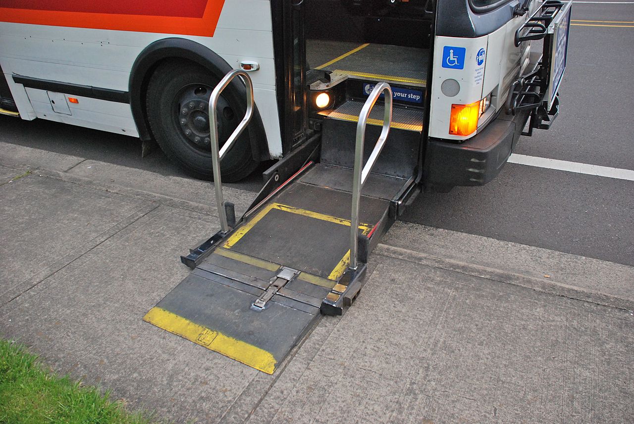 Wheelchair lift lowered from a bus for safe boarding