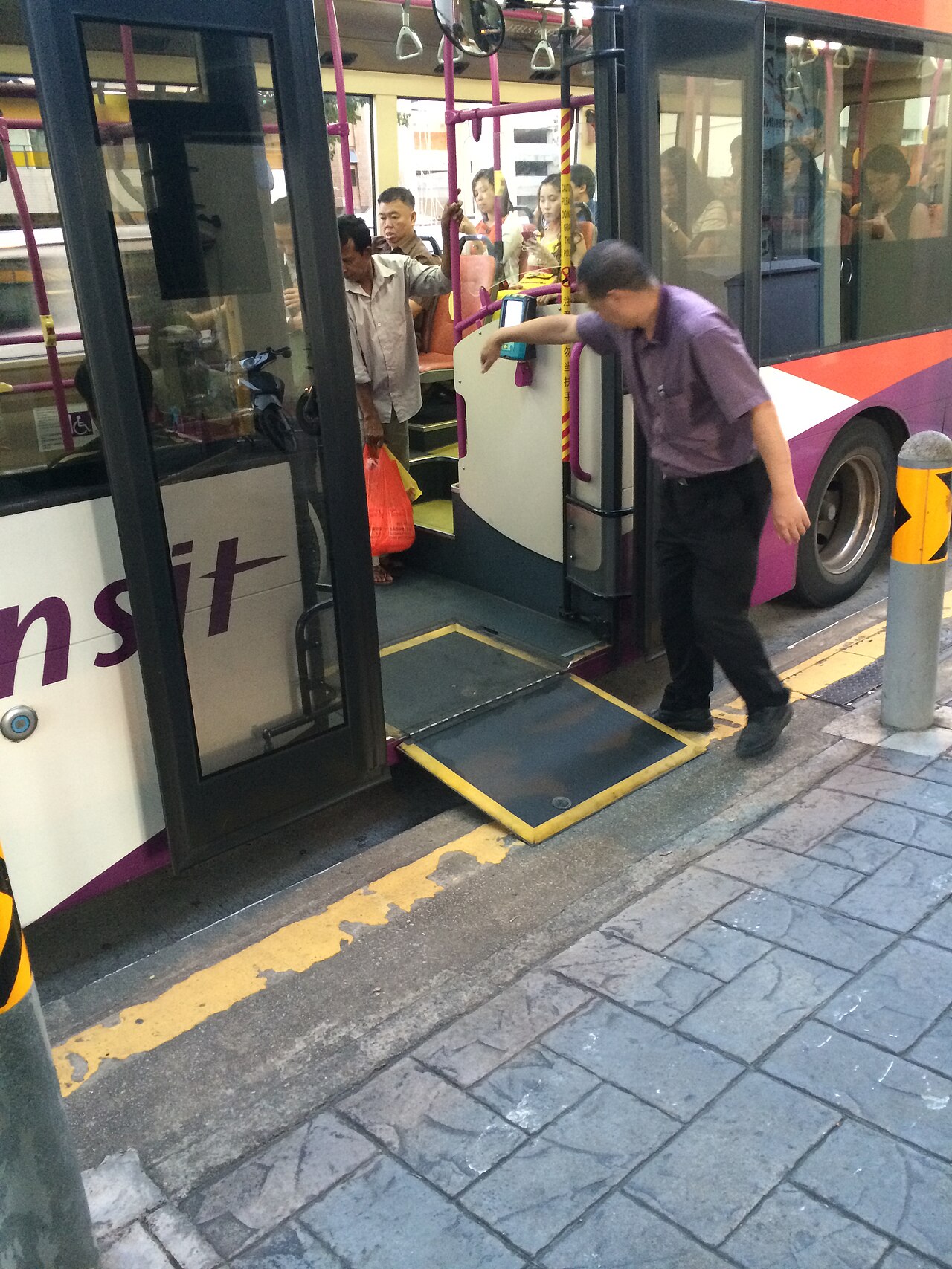 Low-floor bus entry with wheelchair ramp at curb
